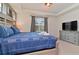 Main bedroom with a king-size bed and dresser at 2174 Fleming Mist Pl, Kissimmee, FL 34747