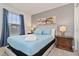 Relaxing bedroom with light blue bedding and wood nightstands at 2174 Fleming Mist Pl, Kissimmee, FL 34747