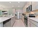 Bright kitchen boasting stainless steel appliances and a large island at 2174 Fleming Mist Pl, Kissimmee, FL 34747