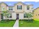 Two-story townhome with landscaped yard and walkway at 2174 Fleming Mist Pl, Kissimmee, FL 34747