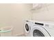 Laundry room with washer, dryer, and shelving at 2174 Fleming Mist Pl, Kissimmee, FL 34747