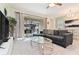 Comfortable living room with glass-top coffee table and sliding doors to patio at 2174 Fleming Mist Pl, Kissimmee, FL 34747