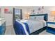 Spacious bedroom with striped bedding and blue accent furniture at 2174 Fleming Mist Pl, Kissimmee, FL 34747
