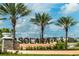 Solara community entrance with palm trees and landscaping at 2174 Fleming Mist Pl, Kissimmee, FL 34747