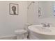 Clean bathroom with a sink, toilet, and shower at 2174 Fleming Mist Pl, Kissimmee, FL 34747