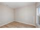 Empty bedroom with light walls, wood floors, and large window at 1322 Current Pl, Haines City, FL 33844