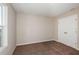 Light-filled bedroom with neutral walls, carpet, and double doors at 1322 Current Pl, Haines City, FL 33844