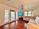Spacious living room featuring hardwood floors, a sectional sofa, and a large TV at 540 Francis Blvd, Lakeland, FL 33801