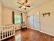 Bedroom with hardwood floors, crib, and ceiling fan at 540 Francis Blvd, Lakeland, FL 33801