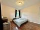 Spacious bedroom with hardwood floors, a double bed, and large windows at 540 Francis Blvd, Lakeland, FL 33801