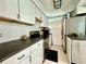 Bright kitchen features white cabinets, dark countertops, and stainless steel appliances at 540 Francis Blvd, Lakeland, FL 33801