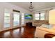 Living room with hardwood floors, sectional sofa, and chandelier at 540 Francis Blvd, Lakeland, FL 33801