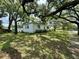 Side view of white house nestled among lush trees at 540 Francis Blvd, Lakeland, FL 33801