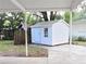 White storage shed in backyard with concrete pad at 540 Francis Blvd, Lakeland, FL 33801