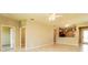 Open living space with tile floors, kitchen views, and access to other rooms at 406 Tortosa Ct, Davenport, FL 33837