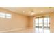 Bright living room with tile floors, sliding glass doors, and ceiling fan at 406 Tortosa Ct, Davenport, FL 33837
