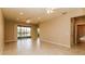 Spacious living area featuring tile floors, access to a patio, and neutral wall colors at 406 Tortosa Ct, Davenport, FL 33837