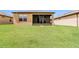 Large backyard with lush green grass and home at 406 Tortosa Ct, Davenport, FL 33837