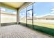Spacious screened patio with brick pavement overlooking backyard at 406 Tortosa Ct, Davenport, FL 33837