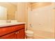 Clean bathroom with a tub, toilet and wood vanity at 406 Tortosa Ct, Davenport, FL 33837