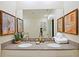 Double vanity bathroom with modern fixtures and a large mirror at 2857 Bookmark Dr, Kissimmee, FL 34746
