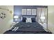 Guest bedroom with a queen-size bed, nightstands, and decorative wall art at 2857 Bookmark Dr, Kissimmee, FL 34746