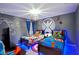 Superhero themed bedroom with twin beds, wall art, and blue lighting at 2857 Bookmark Dr, Kissimmee, FL 34746