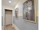 Hallway with two framed botanical prints at 2857 Bookmark Dr, Kissimmee, FL 34746