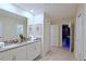 Double vanity bathroom with view of adjacent game room at 2857 Bookmark Dr, Kissimmee, FL 34746