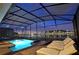 Night view of a relaxing pool and spa with lake view at 2857 Bookmark Dr, Kissimmee, FL 34746