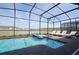Resort-style pool and spa with lounge chairs and lake view at 2857 Bookmark Dr, Kissimmee, FL 34746