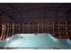 Night view of a pool with lights reflecting in the water at 2857 Bookmark Dr, Kissimmee, FL 34746