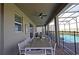 Covered patio with dining table, pool view, and screened enclosure at 2857 Bookmark Dr, Kissimmee, FL 34746