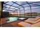 Night view of a relaxing pool and spa with lake view at 2857 Bookmark Dr, Kissimmee, FL 34746
