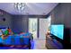 Superhero themed bedroom with twin bed, TV, and plenty of character at 2857 Bookmark Dr, Kissimmee, FL 34746