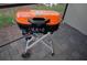 Orange and black Coleman two-burner tabletop gas grill at 2857 Bookmark Dr, Kissimmee, FL 34746