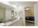 Bathroom with double vanity and view into bedroom at 2857 Bookmark Dr, Kissimmee, FL 34746