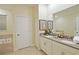Double vanity bathroom with modern fixtures and a large mirror at 2857 Bookmark Dr, Kissimmee, FL 34746