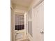 Bathroom with shower and striped curtain, view of hallway at 2857 Bookmark Dr, Kissimmee, FL 34746
