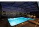 Relaxing nighttime view of a private pool and spa with lake view at 2857 Bookmark Dr, Kissimmee, FL 34746