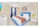 Bedroom with king-size bed and blue headboard at 1959 Tropical Palms Cir, Kissimmee, FL 34747