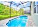 Screened pool and spa with lush landscaping at 1959 Tropical Palms Cir, Kissimmee, FL 34747