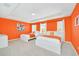 Bedroom with two twin beds and orange walls at 1959 Tropical Palms Cir, Kissimmee, FL 34747