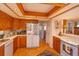 Well-equipped kitchen boasts wood cabinets and modern appliances at 1 John Anderson Dr # 604, Ormond Beach, FL 32176