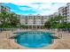 Refreshing community pool with surrounding lounge chairs at 1 John Anderson Dr # 604, Ormond Beach, FL 32176
