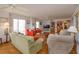 Spacious living room with hardwood floors, ample seating, and views at 1 John Anderson Dr # 604, Ormond Beach, FL 32176