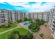Luxury condo complex with a resort-style pool and lush landscaping at 1 John Anderson Dr # 604, Ormond Beach, FL 32176
