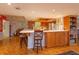 Open kitchen features a large island with seating and wood cabinetry at 1 John Anderson Dr # 604, Ormond Beach, FL 32176