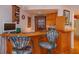 Wet bar with wood cabinets, seating, and beverage storage at 1 John Anderson Dr # 604, Ormond Beach, FL 32176