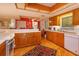 Spacious kitchen with wood cabinets, island, and hardwood floors at 1 John Anderson Dr # 604, Ormond Beach, FL 32176